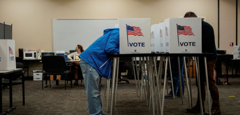 People standing at the voting booth.