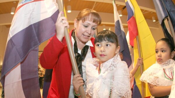 Importance of grandparents: Carmen Dean of Burnsville, Minn., helps her granddaughter, Ana Elizabeth Rodriguez, get ready for a procession at the start of a Mass to celebrate the feast of Our Lady of Guadalupe in this file photo from 2008. (OSV News photo/Dave Hrbacek, Catholic Spirit)