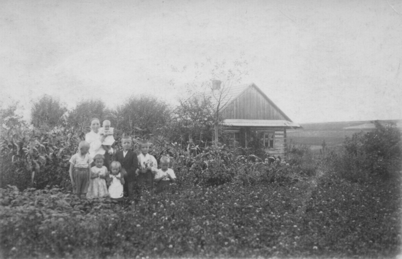 Wiktoria Ulma is pictured in an undated photo with three of her children and the children of relatives outside the Ulma home in Markowa, a village in southeastern Poland. Wikotria, her husband, Józef, and their seven children were executed March 24, 1944, by Nazis who discovered that the family had been sheltering eight Jews who had escaped internment by German occupying forces. Ulma girls Stasia and Basia are pictured in the middle near their mother, who is holding son Wlodzimierz. (CNS photo courtesy National Remembrance Institute)