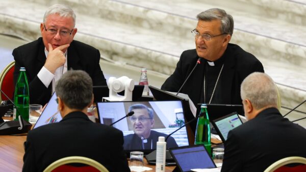 Cardinal Jean-Claude Hollerich, relator general of the synod, listens as Cardinal Mario Grech, secretary-general, introduces the beginning of the assembly of the Synod of Bishops' work in the Vatican's Paul VI Audience Hall Oct. 9, 2023. (CNS photo/Lola Gomez)