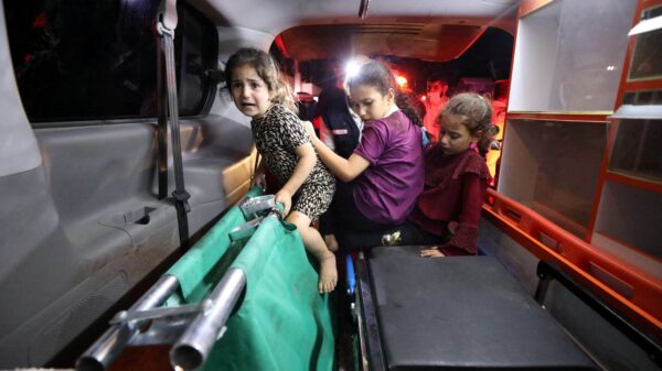 Children sit in the back of an ambulance at Shifa Hospital following an airstrike on the CNEWA-supported al-Ahli Arab Hospital in Gaza City Oct. 17, 2023. (OSV News photo/Mohammed Al-Masri, Reuters)