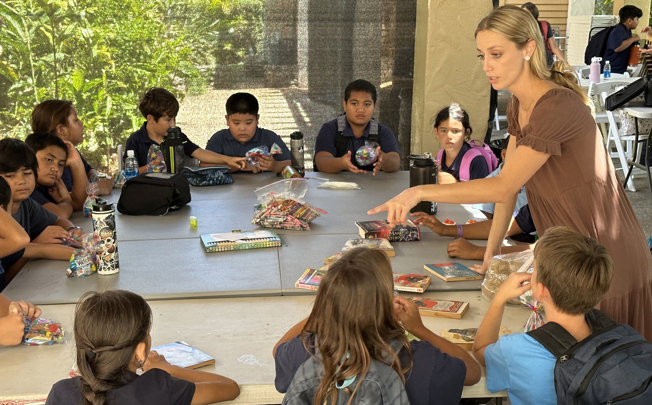 Cara Camanse, a fourth-grade teacher at Sacred Hearts School in Lahaina on the Hawaiian island of Maui, is pictured in an undated photo leading students at Sacred Hearts Mission Church in nearby Kapalua. The school has been temporarily located to the church since the wildfires of Aug. 8-9, 2023, driven by high winds, destroyed most of the school building in the historic town of Lahaina, along with more than 2,200 other buildings there. (OSV News photo/courtesy Brian Perry)