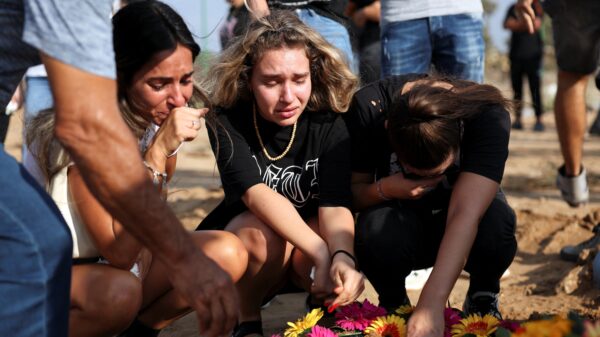 People mourn at the graveside of Eden Guez during her funeral in Ashkelon, Israel, Oct. 10, 2023. She was killed during an Oct. 7 music festival that was attacked by Hamas gunmen from Gaza. Israel increased airstrikes on the Gaza Strip and sealed it off from food, fuel and other supplies Oct. 9 in retaliation for a bloody incursion by Hamas militants. (OSV News photo/Violeta Santos Moura, Reuters)