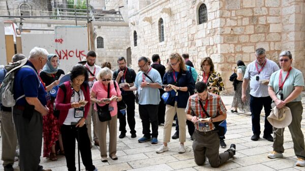 Pilgrims from the Diocese of Arlington, Va., pray in the courtyard of the Church of the Holy Sepulcher in Jerusalem's Old City Oct. 10, 2023. Pilgrims who were in Israel following a surprise terrorist attack by Hamas against civilian communities in southern Israel Oct. 7 lit candles and said prayers of peace at the church as fighting continued in southern Israel. (OSV News photo/Debbie Hill)