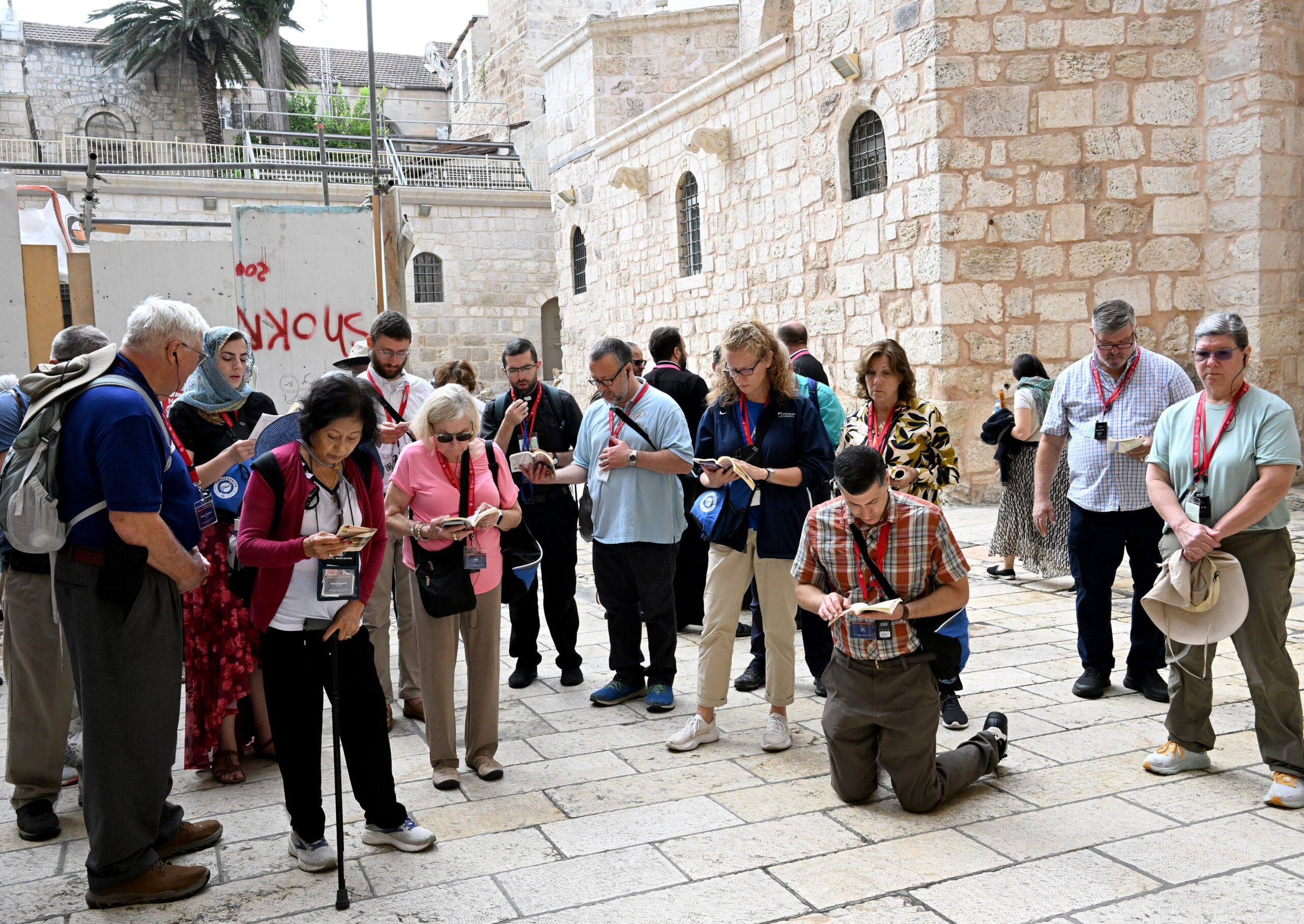 Pilgrims from the Diocese of Arlington, Va., pray in the courtyard of the Church of the Holy Sepulcher in Jerusalem's Old City Oct. 10, 2023. Pilgrims who were in Israel following a surprise terrorist attack by Hamas against civilian communities in southern Israel Oct. 7 lit candles and said prayers of peace at the church as fighting continued in southern Israel. (OSV News photo/Debbie Hill)