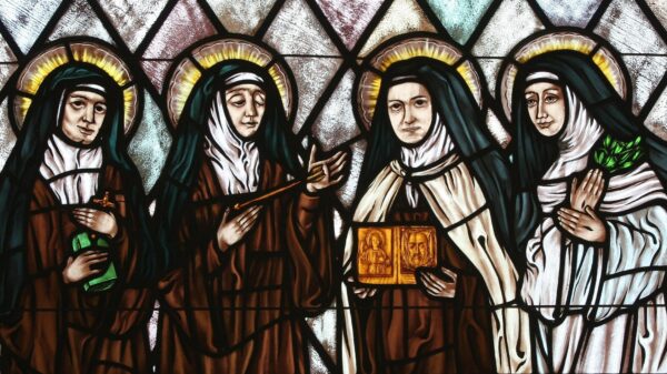St. Therese of Lisieux is featured holding an image of the Holy Face in this stained glass depiction of beloved female saints in the church of St. Therese, Montauk, N.Y. Illustrated are Sts. Teresa Benedicta of the Cross, Theresa of Avila, Therese of Lisieux and Catherine of Siena. (OSV News photo/Gregory A. Shemitz)