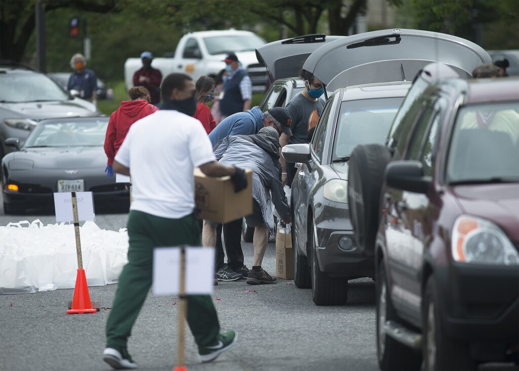 Catholic Charities staff and volunteers in the Archdiocese of Washington distribute boxes of nutritious grocery items to families in need in the parking lot of the Basilica of the National Shrine of the Immaculate Conception May 19, 2020. Among its seven themes, Catholic social teaching emphasizes an option for the poor and vulnerable, calling Catholics to "imitate Christ's love for the poor by working to create a society where the needs of the poor are always considered first." (OSV News photo/CNS file, Tyler Orsburn)