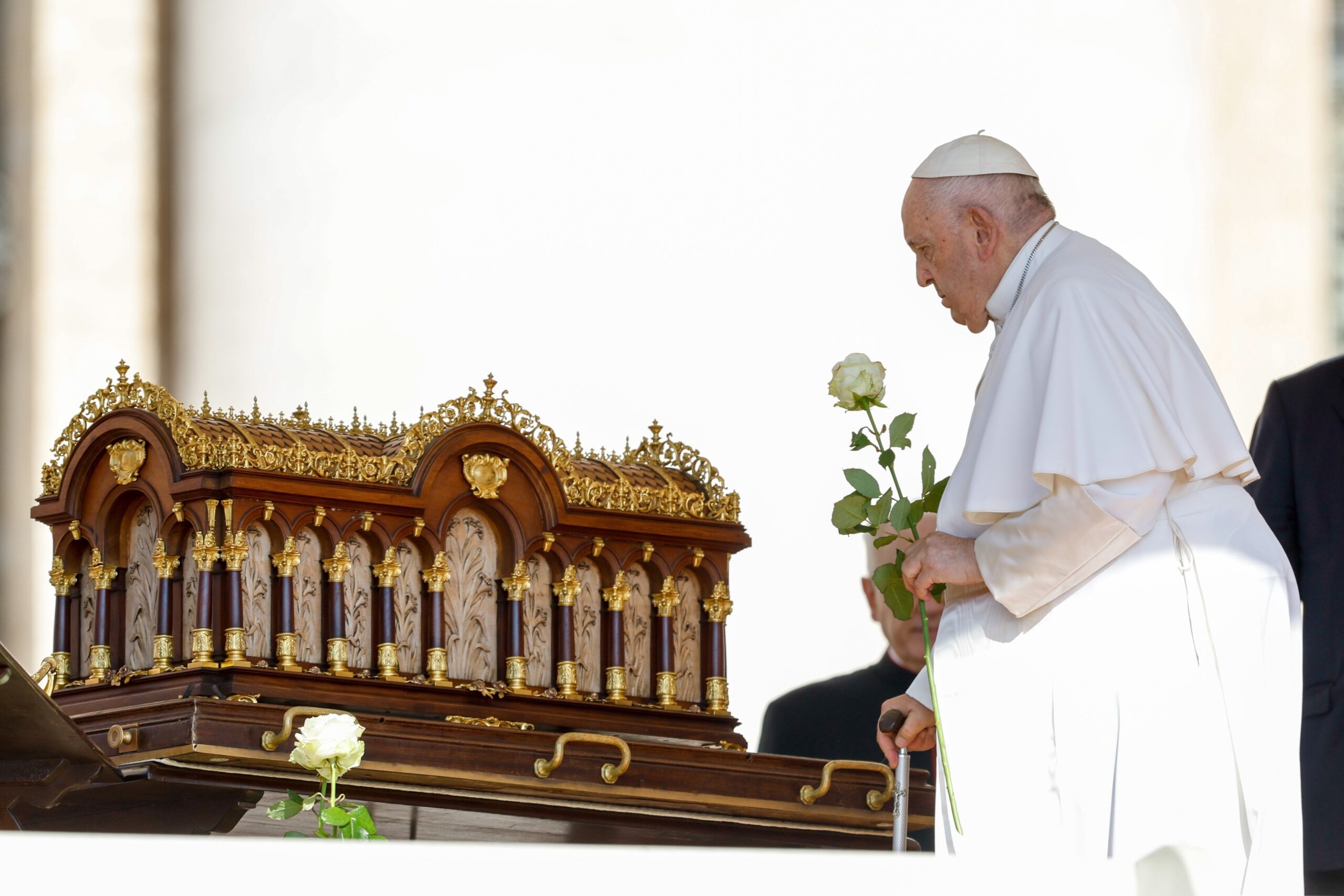 Pope Francis carries a white rose as he approaches a reliquary containing the relics of St. Thérèse of Lisieux before the start of his general audience in St. Peter's Square at the Vatican June 7, 2023. The pope issued an apostolic letter Oct. 15 that was dedicated to the saint for the 150th anniversary of her birth. (CNS photo/Lola Gomez)