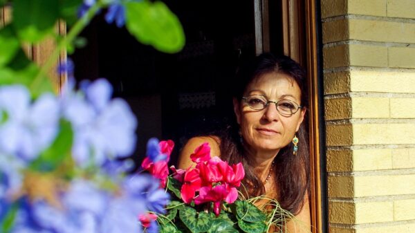 A Roman woman strikes a serene pose as she encounters the world outside her window. (OSV News photo/Valter Cirillo, Pixabay)