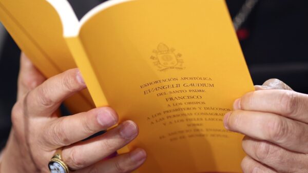 A copy of the apostolic exhortation "Evangelii Gaudium" ("The Joy of the Gospel") by Pope Francis is seen during a news conference at the Vatican Nov. 26, 2013. In his first extensive piece of writing as pope, Pope Francis lays out a vision of the Catholic Church dedicated to evangelization, with a focus on society's poorest and most vulnerable, including the aged and unborn. (CNS photo/Alessandro Bianchi, Reuters)