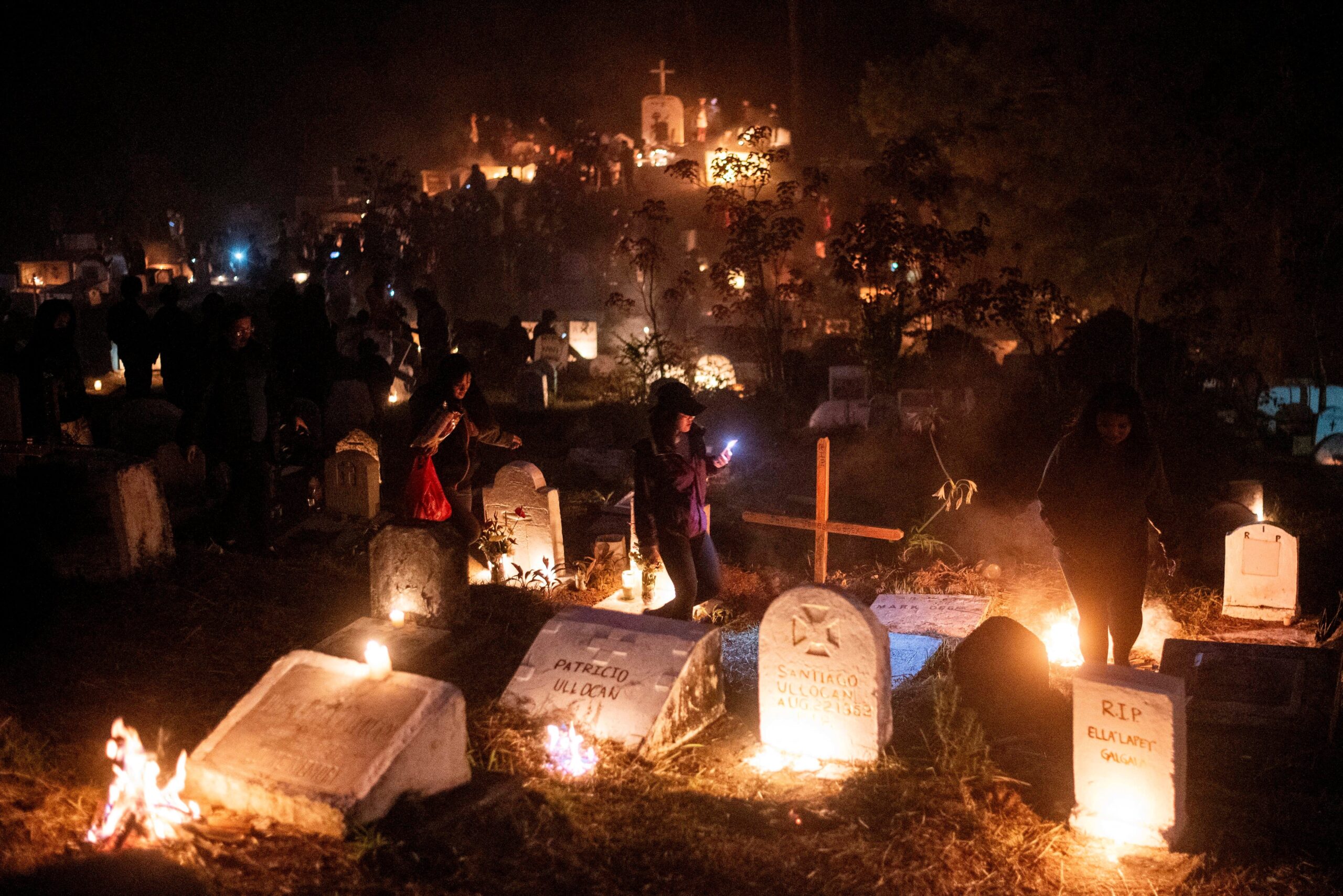 People light candles and burn pine woods as they visit the graves of departed loved ones on All Saints' Day, in Sagada town, Mountain Province, Philippines, Nov. 1, 2023. (OSV News photo/Lisa Marie David, Reuters)