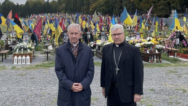 U.S. Bishop Jeffrey M. Monforton, right, poses with Father Bohdan Prakh, former president of the Ukrainian Catholic University in Lviv, at a military cemetery in Lviv. While in Lviv, Bishop Monforton spoke with family members who have lost loved ones during the war. The bishop, former head of the Diocese of Steubenville, Ohio, traveled to the war-torn nation on a personal visit of solidarity Oct. 18-22, 2023. Bishop Monforton officially began his ministry as the newest auxiliary bishop of the Detroit Archdiocese Nov. 7. (OSV News photo/courtesy Ukrainian Greek Catholic Church via Detroit Catholic) Editors: best quality available.