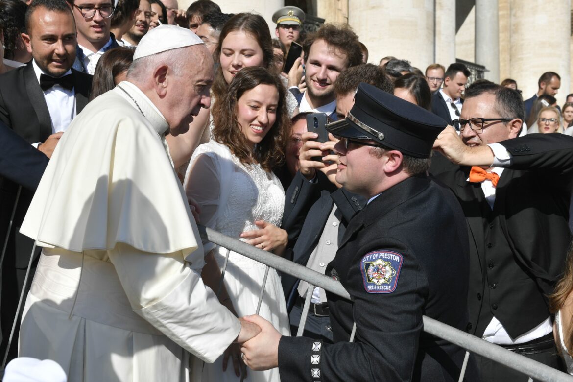 A man has a personal encounter with Pope Francis outside at the weekly general audience.