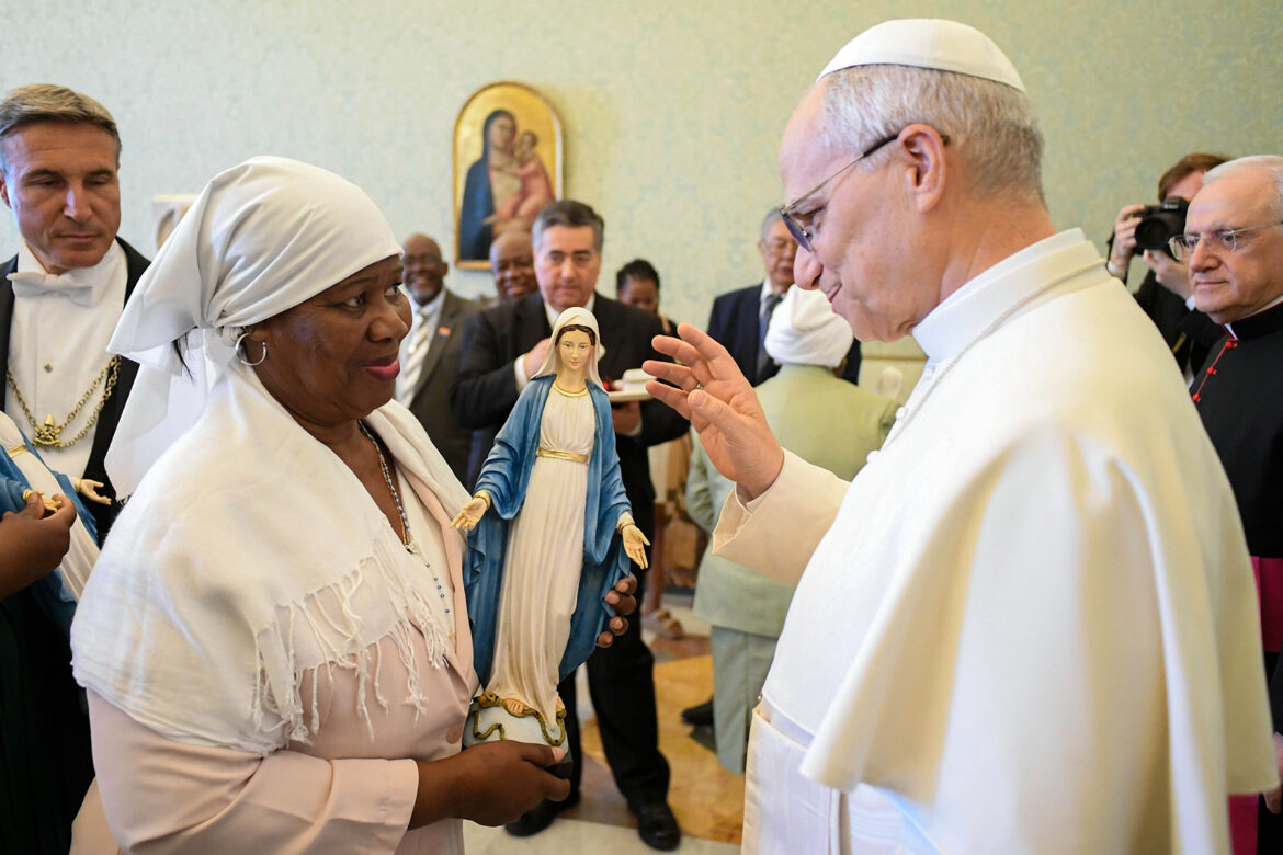 Pope Leo XIV blesses a statue of the Blessed Virgin Mary during a meeting at the Vatican Aug. 23, 2025, with refugees and their descendants who were exiled from the Chagos Islands to clear the way for the establishment of a major U.S. and U.K. military base on Diego Garcia, the largest island. (CNS photo/Vatican Media)