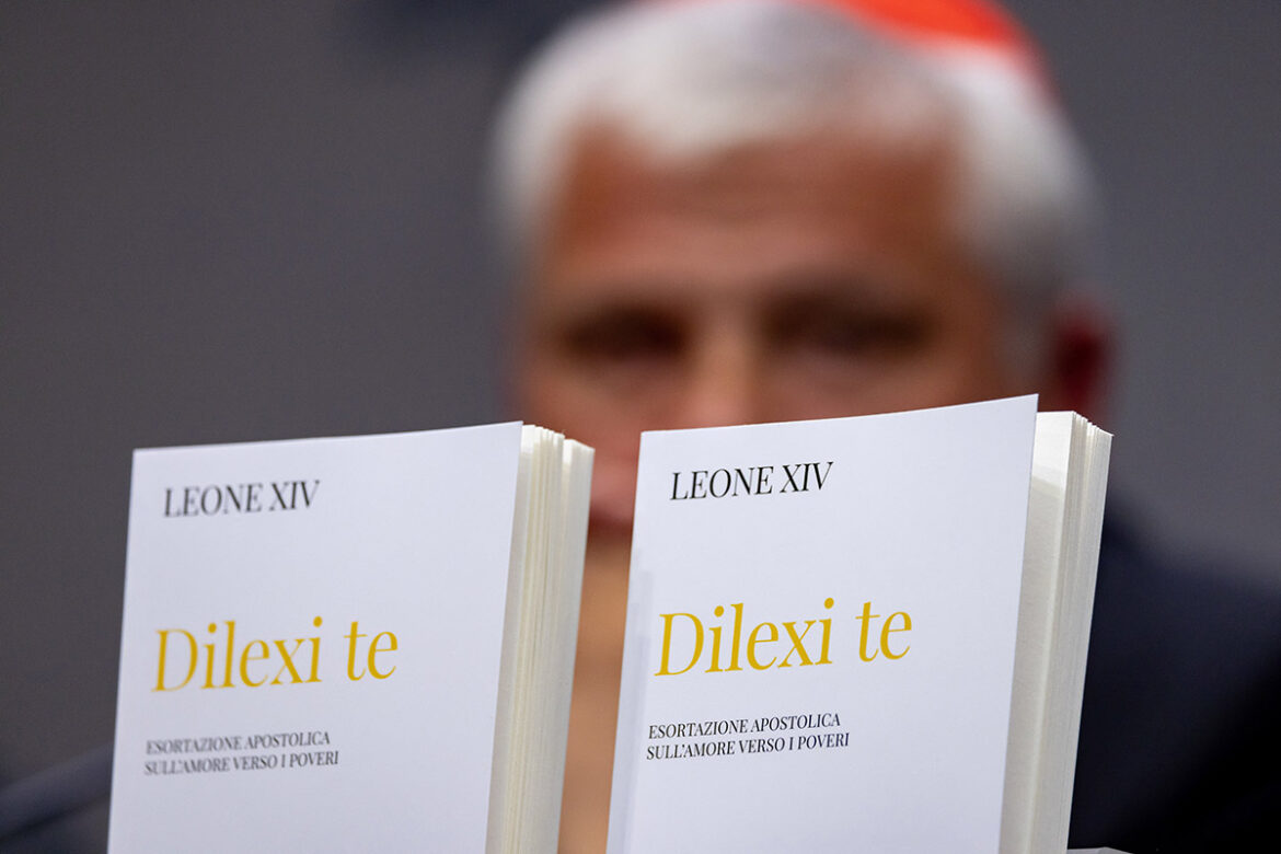 Copies of the Italian translation of "Dilexi Te" ("I Have Loved You"), Pope Leo XIV's apostolic exhortation, are seen in front of Cardinal Konrad Krajewski, prefect of the Dicastery for the Service of Charity, at a Vatican news conference Oct. 9, 2025. (CNS photo/Pablo Esparza)