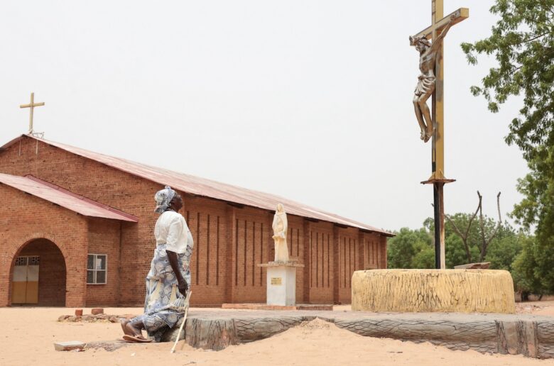 A Catholic worshipper kneels before a crucifix on Easter April 5, 2026, outside the Cathedral of St. Anne in Yagoua, Cameroon. (OSV News photo/Desire Danga, Reuters)