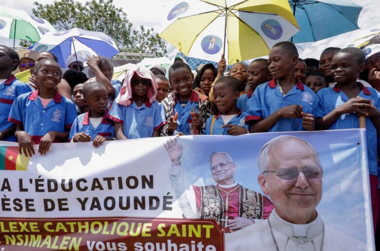 Catholic school students hold a banner as the faithful gather at Yaounde Nsimalen International Airport in Yaounde, Cameroon, April 15, 2026, before Pope Leo XIV's arrival to begin his apostolic journey to the African country. Late on April 13, separatist factions operating in Cameroon's Anglophone regions announced a temporary cessation of hostilities would be in place during the papal visit. (OSV News photo/Luc Gnago, Reuters)