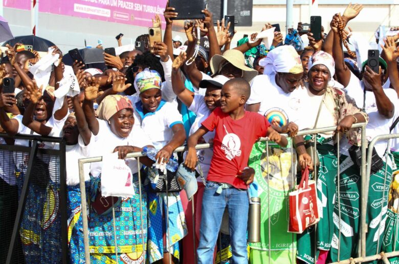People wave during the arrival of Pope Leo XIV on the streets of Luanda, Angola, to begin his apostolic journey to Angola, April 18, 2026. (OSV News photo/Cesar Muginga, Reuters)