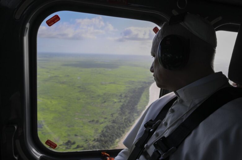 Pope Leo XIV looks out of the window of the helicopter on his way to pray the rosary at the Sanctuary of Our Lady of Muxima in Muxima, Angola, April 19, 2026. (OSV News photo/Simone Risoluti, Vatican Media)