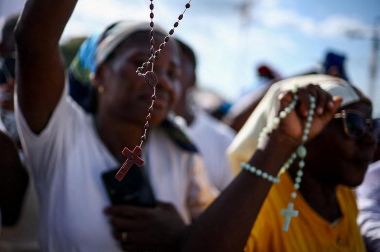 People hold rosaries ahead of the rosary prayer led by Pope Leo XIV at the "Mama Muxima" Shrine,  during his apostolic journey in Africa, in Muxima, Angola, April 19, 2026. (OSV News photo/Guglielmo Mangiapane, Reuters)