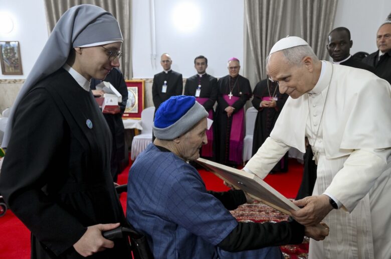 Pope Leo XIV receives a painting from a resident as he visits the nursing home of the Little Sisters of the Poor in Annaba, Algeria, April 14, 2026. (OSV News photo/Simone Risoluti, Vatican Media)