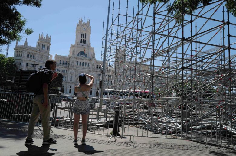 People take pictures near a steel tribune structure in Madrid's Plaza de Cibeles May 28, 2026. The site is being prepared for an audience ahead of Pope Leo XIV's June 6-12 apostolic visit to Spain. (OSV News photo/Kacper Pempel, Reuters)