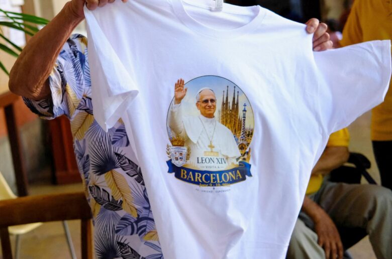 A faithful holds a T-shirt with an image of Pope Leo XIV before a Mass at St. Augustine church, also known as the "Church of the Migrants," in Barcelona, Spain, May 31, 2026, ahead of Pope Leo's June 6-12 apostolic visit to Spain. (OSV News photo/Nacho Doce, Reuters)