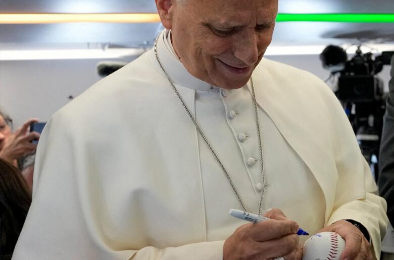 Pope Leo XIV signs a baseball ball presented by Spanish photojournalist Daniel Ibanez Gutierrez aboard the papal flight from Rome to Madrid, June 6, 2026, on the occasion of his apostolic journey to Spain. (OSV News/Violeta Alessandra Tarantino, Reuters)