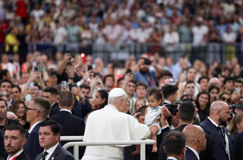 Pope Leo XIV greets a child as he arrives for a meeting with the diocesan community at the Santiago Bernabeu Stadium in Madrid June 8, 2026, during his June 6-12 apostolic journey to Spain. (OSV News photo/Yara Nardi, Reuters)