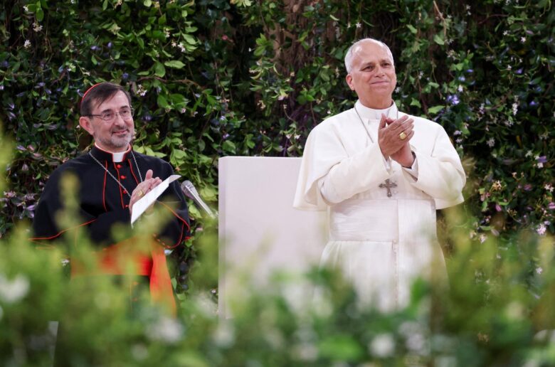 Pope Leo XIV applauds alongside Cardinal José Cobo of Madrid after arriving for a meeting with the diocesan community at the Santiago Bernabeu Stadium in Madrid June 8, 2026, during his June 6-12 apostolic journey to Spain. (OSV News photo/Yara Nardi, Reuters)