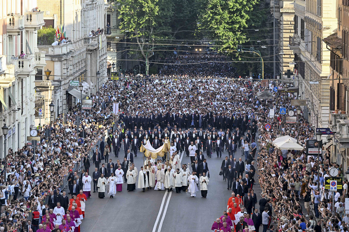 Under a canopy, Pope Leo XIV carries the Eucharist in a monstrance during a Corpus Christi procession from Rome's Basilica of St. John Lateran to the Basilica of St. Mary Major June 22, 2025. Thousands of people participated in the procession behind the pope and thousands more lined the streets as the procession passed. (CNS photo/Vatican Media)