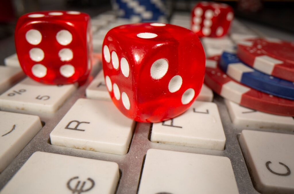 Gambling dice and chips are seen on the keyboard in this illustration picture, June 5, 2020. The sports betting industry has seen explosive growth in revenue in the past six years. (OSV News photo/Dado Ruvic, Reuters/Illustration)
