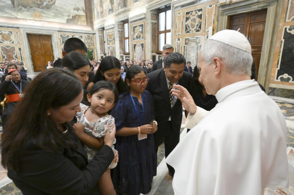 Pope Leo XIV blesses a child as he meets with participants of the XVII Annual Meeting of International Catholic Legislators Network at the Vatican Aug. 21, 2026. (OSV News photo/Matteo Pernaselci, Vatican Media)
