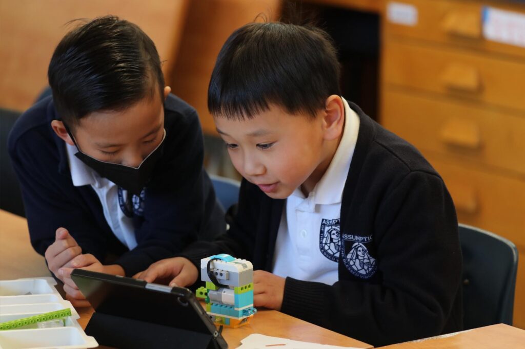 First-graders Connor Nguyen and Jasper Zhao work in a science, technology, engineering and math program, or STEM, at Assumption of the Virgin Mary School in Pasadena, Calif., Jan. 15, 2025. At the start of a new school year, Catholic educators describe how they are making use of AI and responding to its challenges. (OSV News photo/Bob Roller)