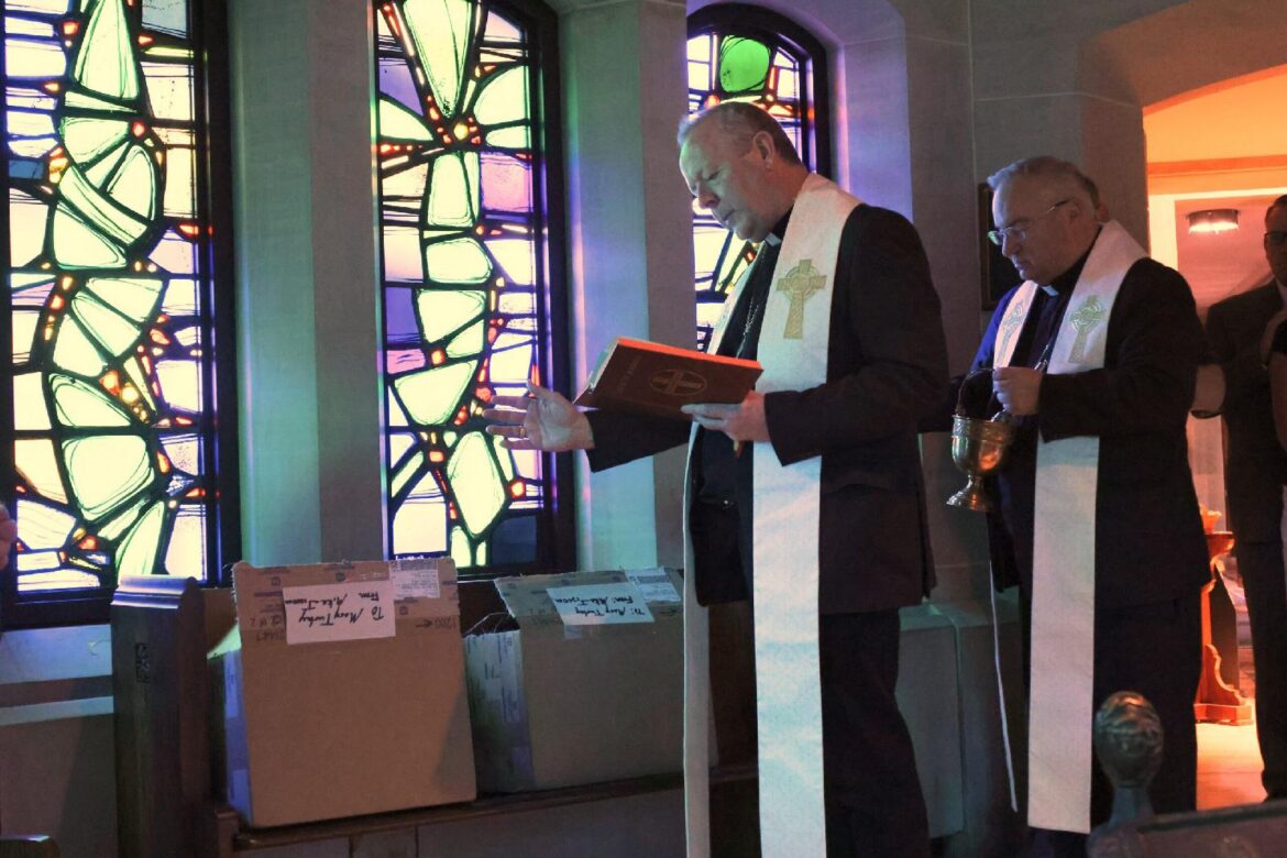 Irish Archbishop Eamon Martin of Armagh blesses Venerable Father Edward Flanagan medals with Archbishop Michael G. McGovern of Omaha, Neb., near the tomb of the Omaha priest and founder of Boys Town at Dowd Memorial Chapel of the Immaculate Conception in Omaha July 16, 2026. The parish serves the village of Boys Town. (OSV News photo/Riley Johnson, The Catholic Voice)