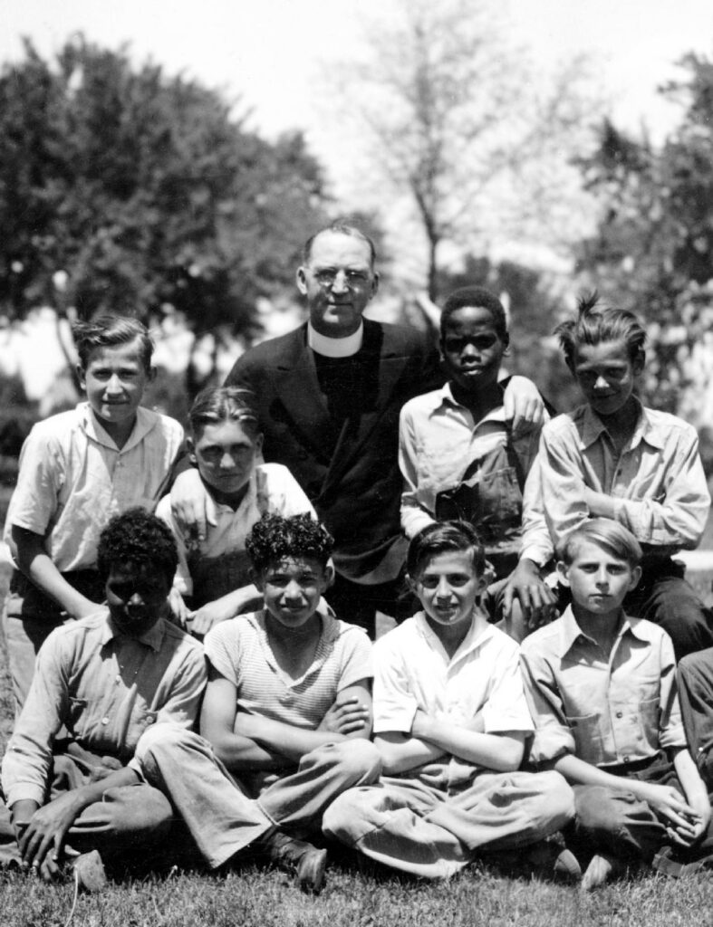 Father Edward Flanagan, the Irish-born priest who founded Boys Town in Nebraska, poses with a group of boys in 1936. Pope Leo XIV declared Father Flanagan venerable in recognition of his heroic virtue March 23, 2026. (OSV News photo/courtesy Boys Town)