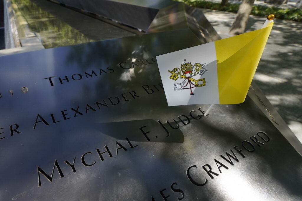 A Vatican flag is seen near the inscription of Franciscan Father Mychal Judge's name at the South Pool of the 9/11 Memorial in New York City Sept. 8, 2025. Father Judge, a chaplain with the New York Fire Department, was killed while ministering at the World Trade Center during the Sept. 11, 2001, terror attacks. The 25th anniversary of the attacks will be observed in 2026. (OSV News photo/Gregory A. Shemitz)