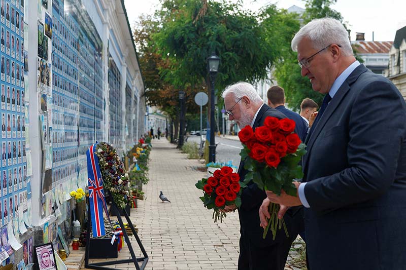 Archbishop Paul R. Gallagher, the Vatican foreign minister, and Ukrainian Foreign Minister Andrii Sybiha place flowers at the Wall of Remembrance of the Fallen Defenders of Ukraine outside St. Michael's Cathedral in Kyiv, Ukraine, July 20, 2026, amid Russia's attack on Ukraine. (OSV News photo/Valentyn Ogirenko, Reuters)