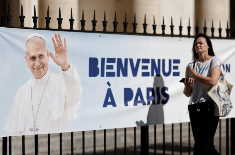 A woman walks past a banner welcoming Pope Leo XIV displayed in front of a church in Paris Sept. 3, 2026, ahead of Pope Leo's Sept. 25-28 visit to France. (OSV News photo/Benoit Tessier, Reuters)