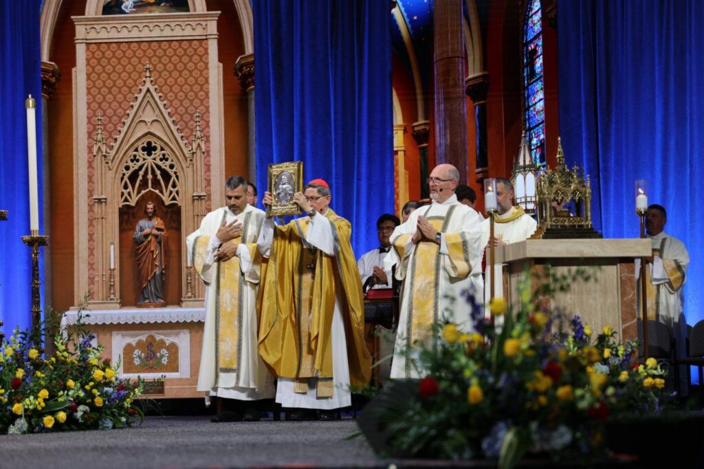 Cardinal Luis Tagle, pro-prefect of the Dicastery for Evangelization, elevates the book of the Gospels at the beatification Mass for Blessed Fulton J. Sheen held Sept. 24, 2026, at The Dome at America's Center in St. Louis. (OSV News photo/Margaret Murray)