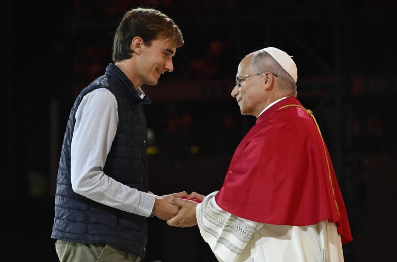 Pope Leo XIV greets a young man during a prayer vigil with young people at the Stade de France in Saint-Denis, France, Sept. 25, 2026, as part of the pope's four-day apostolic journey to France. (OSV News photo/Simone Risoluti, Vatican Media)