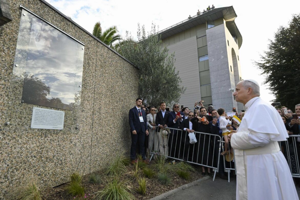 Pope Leo XIV stops to view a memorial plaque for victims of clerical sexual abuse at Lourdes ahead of a meeting with the French Bishops Conference at the Sanctuary of Our Lady of Lourdes during his apostolic journey to France, in Lourdes, France, Sept. 27, 2026. (OSV News photo/Simone Risoluti, Vatican Media)