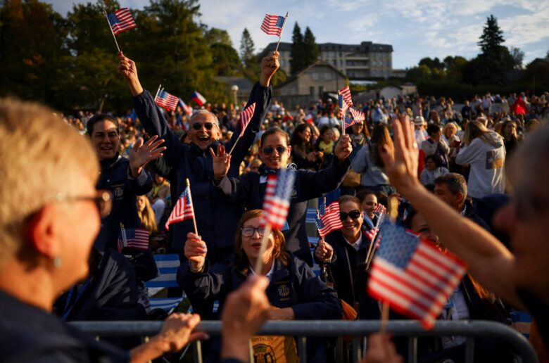 People wave U.S. flags as they wait for the arrival of Pope Leo XIV to celebrate a Sunday Mass on the prairie at the Sanctuary of Our Lady of Lourdes, as part of his four-day apostolic journey to France, in Lourdes, France, Sept. 27, 2026. (OSV News photo/Stephane Mahe, Reuters)
