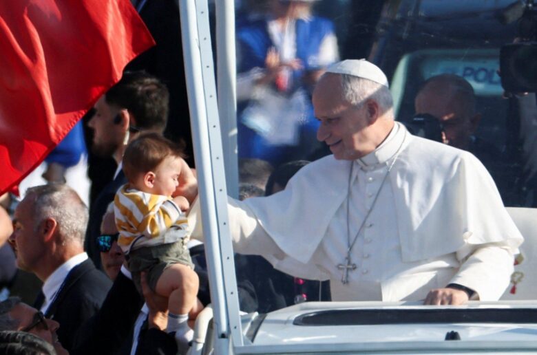 Pope Leo blesses a child from his Popemobile as he arrives to celebrate Sunday Mass on the prairie at the Sanctuary of Our Lady of Lourdes, as part of his four-day apostolic journey to France, in Lourdes, France, Sept. 27, 2026. (OSV News photo/Stephane Mahe, Reuters)