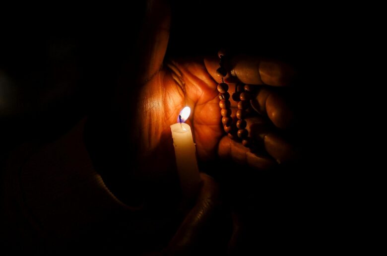 A member of the faithful attends a candlelight procession at the Sanctuary of Our Lady of Lourdes during during his four-day apostolic journey to France, in Lourdes, France, Sept. 27, 2026. (OSV News photo/Stephane Mahe, Reuters)