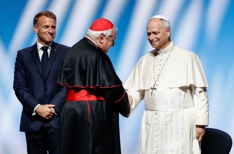 Cardinal Jean-Marc Aveline of Marseille shakes hands with Pope Leo XIV next to French President Emmanuel Macron as they attend a meeting titled "At the Roots of Europe for Peace and Unity" at the Robert Schuman convention center in Metz Sept. 28, 2026, as part of Pope Leo's four-day apostolic journey to France. (OSV News photoBenoit Tessier, pool via Reuters)