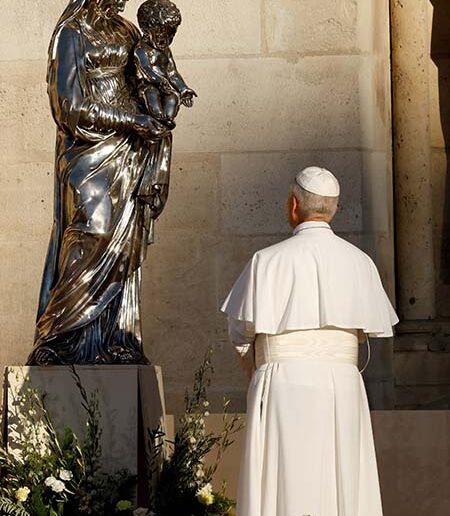 Pope Leo prays in front of a statue outside Notre Dame Cathedral at the end of a celebration of Vespers with bishops, priests, deacons, consecrated men and women and seminarians  in Paris Sept. 25, 2026. The visit to the iconic temple is part of the pope's four-day apostolic journey to France. (OSV News/Remo Casilli, Reuters)
