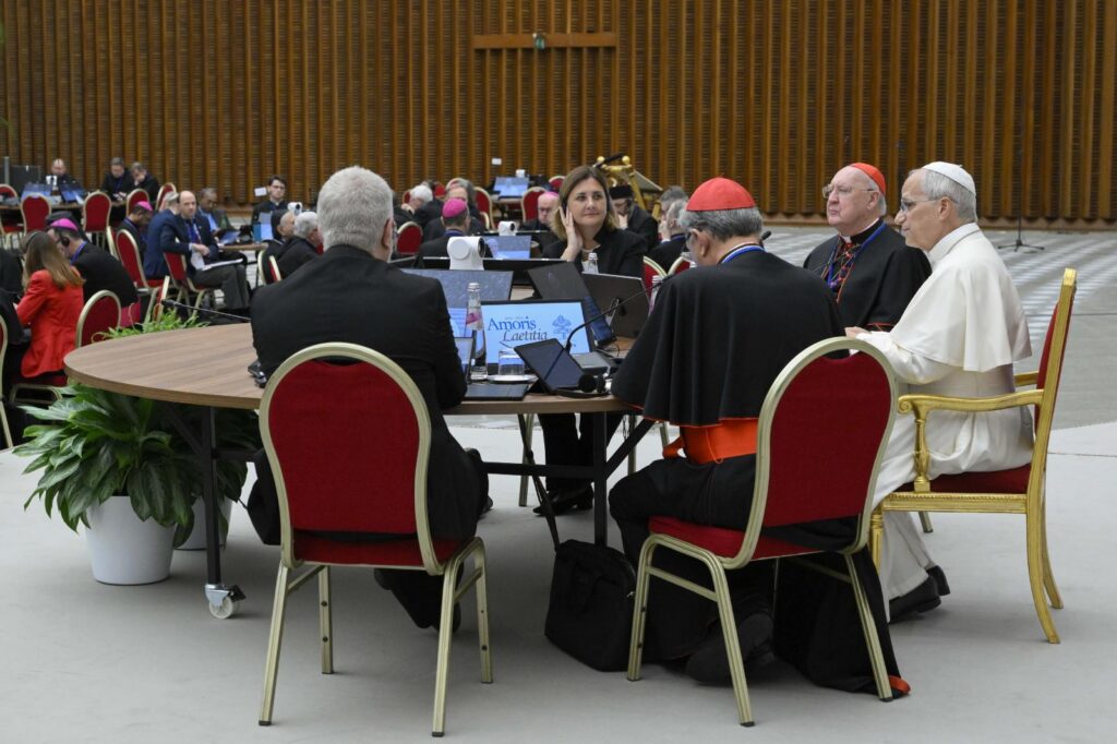 Pope Leo XIV talks at a table with prelates and laypeople Oct. 7, 2026, after he opened the weeklong Vatican meeting of presidents of bishops' conferences marking the 10th anniversary of “Amoris Laetitia” ("The Joy of Love"). On Oct. 8, 2026, the second day of Pope Leo XIV's meeting, Cardinal Filipe Neri Ferrão of Goa, India, told the Vatican bishops' meeting about success a parish in his archdiocese in India has had with pastoral family visits and phone-free family evenings (OSV News photo/Simone Risoluti, Vatican Media)