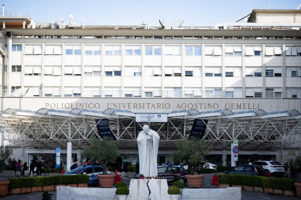 A statue of St. John Paul II Oct. 14, 2026, can be seen in front of Rome's Gemelli hospital where Pope Leo XIV is recovering from surgery during which doctors removed his lower right lung to treat a cancerous tumor. (CNS photo/Cristian Gennari)